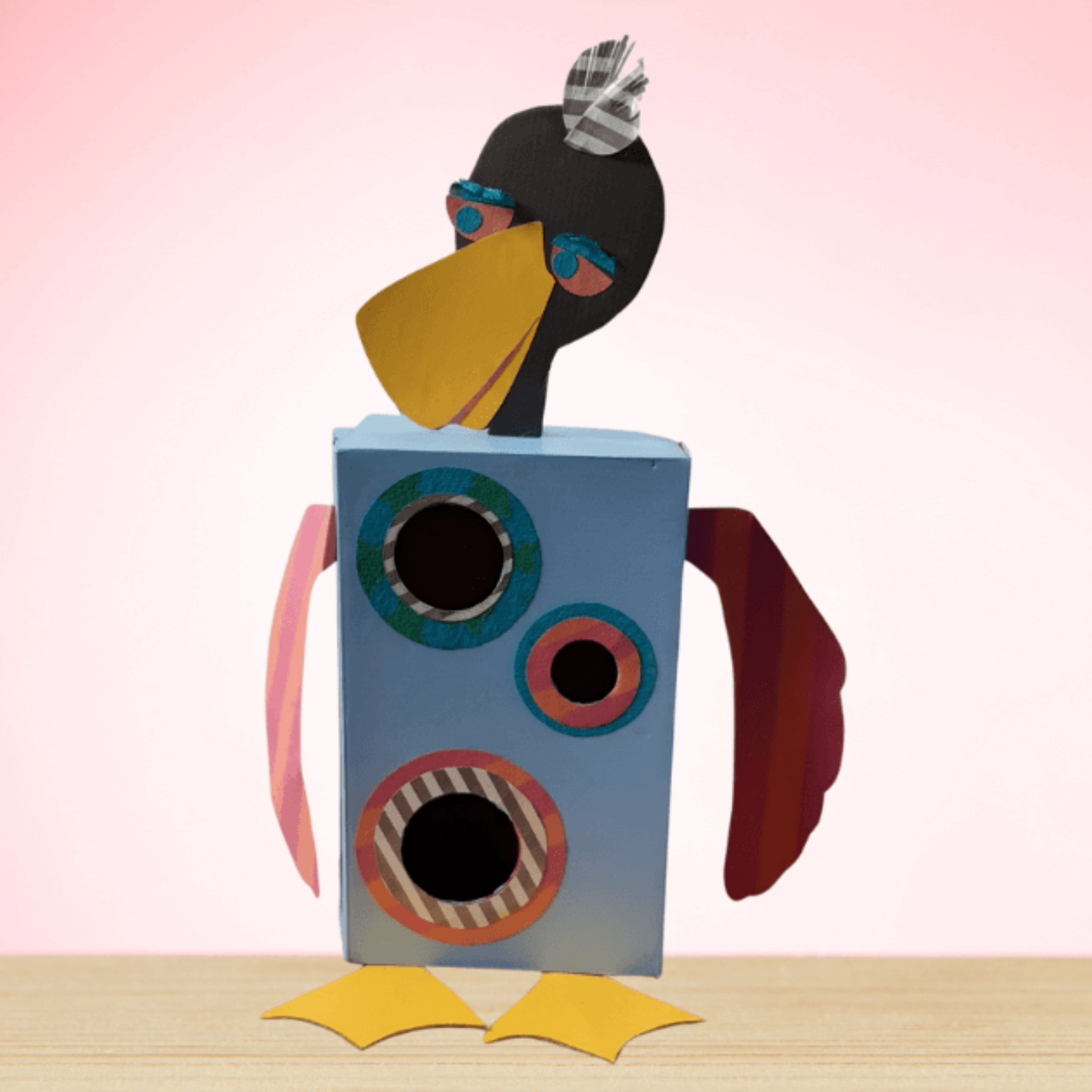 Crafted duck from recycled materials, including a shoebox and different coloured papers.