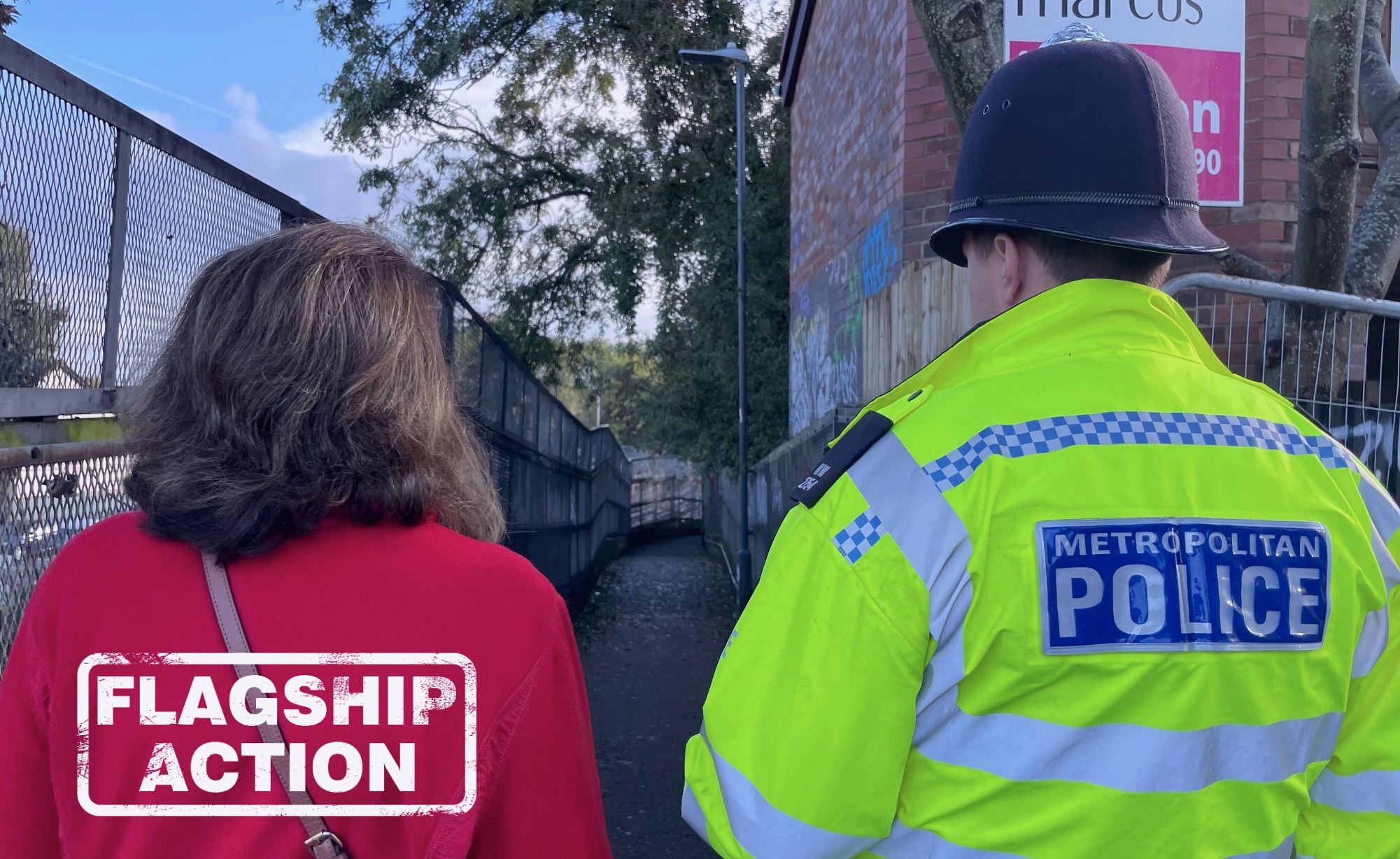 Week of action: photo of police with Anjana looking at an alleyway