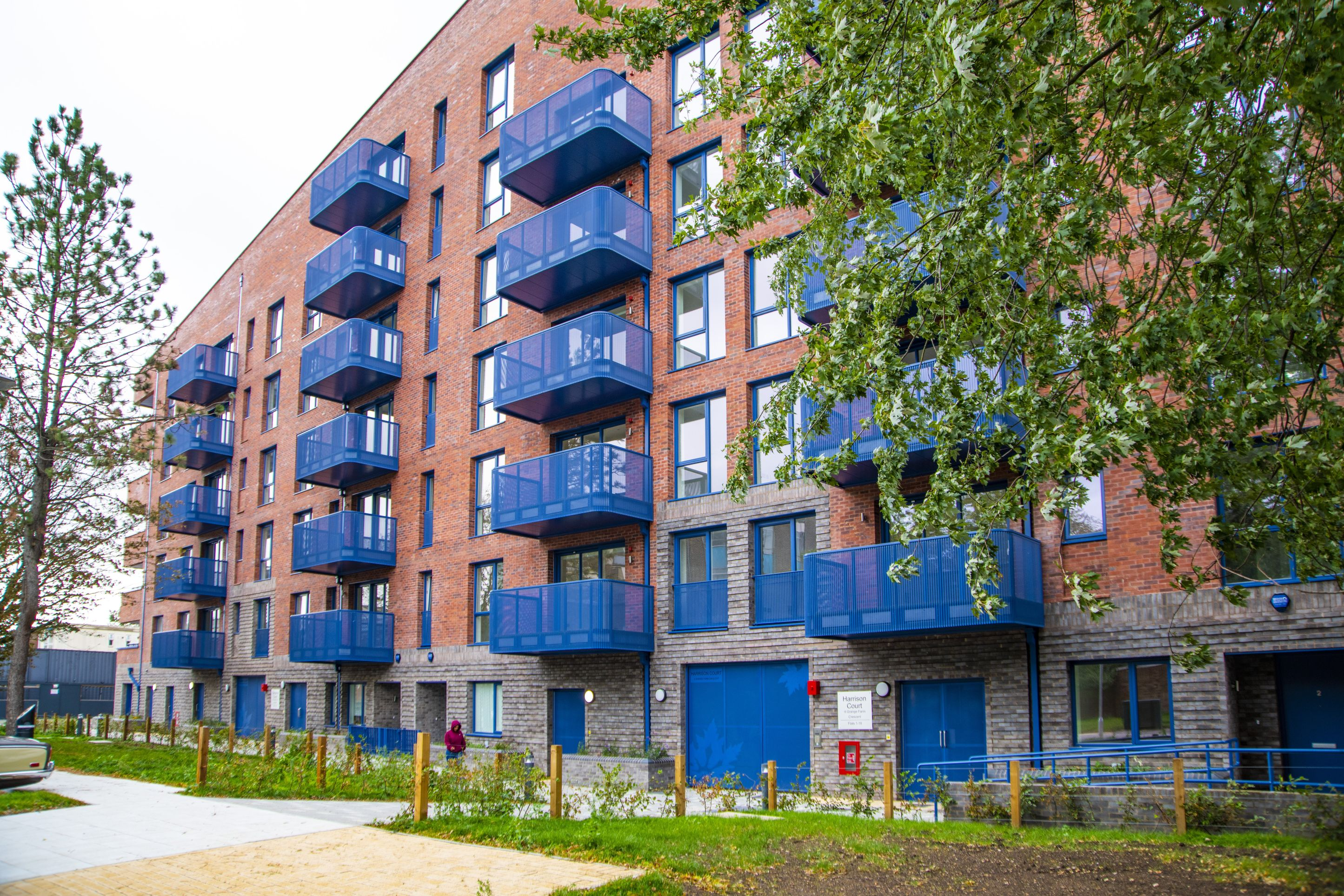 Block of newly built flats with blue balconies