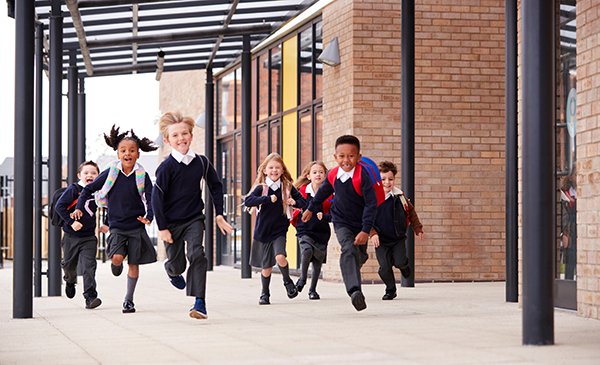 A group of children running out of school